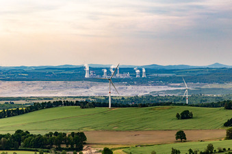 Oblique view of Czech wind farm Wetzwalde (Větrný park Václavice) in front of the Polish brown coal open-cast mine Kopalnia Węgla Brunatnego Turów in Hrádek nad Nisou in the state Liberec, Czech Republic