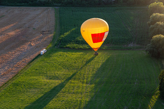 Landing of two hot air balloons "Pfalzgas in Winden in the state Rhineland-Palatinate, Germany seen from above