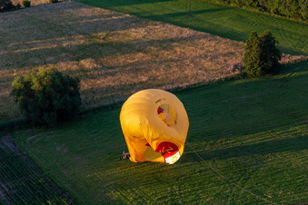 Bird's eye view of Landing of two hot air balloons "Pfalzgas in Winden in the state Rhineland-Palatinate, Germany