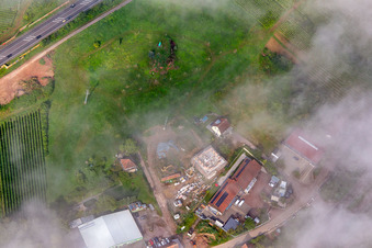 Aerial view of Construction site for multi-family house below the light blue Statue of Liberty on the slope at Kolchenbachstraße in Albersweiler in the state Rhineland-Palatinate, Germany