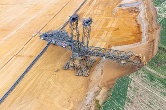 Giant hoisting crane eats into former farmland for the western expansion of the Garzweiler open-cast lignite mine in the district Immerath in Erkelenz in the state North Rhine-Westphalia, Germany from above