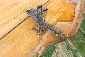 Giant hoisting crane eats into former farmland for the western expansion of the Garzweiler open-cast lignite mine in the district Immerath in Erkelenz in the state North Rhine-Westphalia, Germany seen from above
