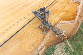 Giant hoisting crane eats into former farmland for the western expansion of the Garzweiler open-cast lignite mine in the district Immerath in Erkelenz in the state North Rhine-Westphalia, Germany from the plane