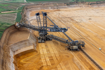 Giant hoisting crane eats into former farmland for the western expansion of the Garzweiler open-cast lignite mine in the district Immerath in Erkelenz in the state North Rhine-Westphalia, Germany viewn from the air