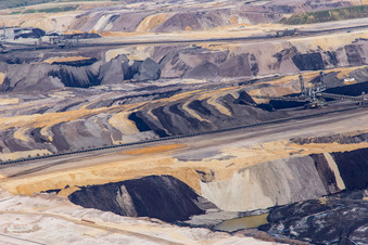 Interestingly colored layers of overburden and coal in the Garzweiler opencast lignite mine in the district Borschemich in Erkelenz in the state North Rhine-Westphalia, Germany