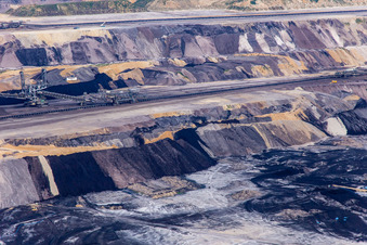 Aerial view of Interestingly colored layers of overburden and coal in the Garzweiler opencast lignite mine in the district Borschemich in Erkelenz in the state North Rhine-Westphalia, Germany