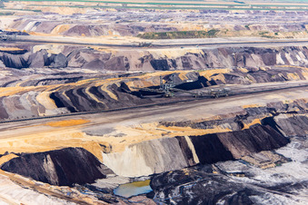 Interestingly colored layers of overburden and coal in the Garzweiler opencast lignite mine in the district Borschemich in Erkelenz in the state North Rhine-Westphalia, Germany from above