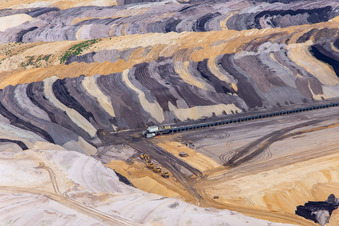 Interestingly colored layers of overburden and coal in the Garzweiler opencast lignite mine in the district Borschemich in Erkelenz in the state North Rhine-Westphalia, Germany out of the air