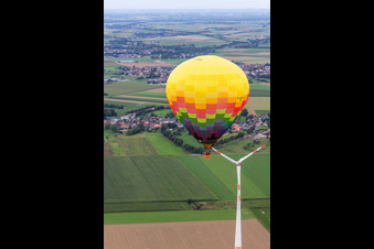 Aerial view of Hot air balloon flies close to the wind turbine in the district Straeten in Heinsberg in the state North Rhine-Westphalia, Germany