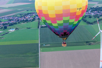 Aerial photograpy of Hot air balloon flies close to the wind turbine in the district Straeten in Heinsberg in the state North Rhine-Westphalia, Germany