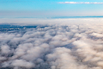 Rotors of the wind farm near Offenbach rise above the low clouds in Offenbach an der Queich in the state Rhineland-Palatinate, Germany