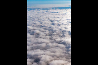 Rotors of the wind farm at Hatzenbühl rise above the low clouds in Hatzenbühl in the state Rhineland-Palatinate, Germany