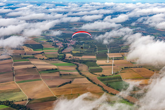 Paraglider over the wind farm Freckenfeld in clouds in Freckenfeld in the state Rhineland-Palatinate, Germany