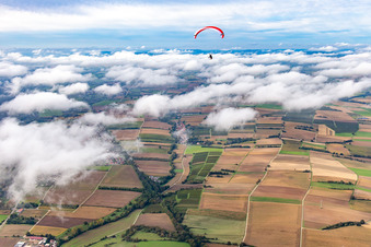Paraglider over the village in clouds in Vollmersweiler in the state Rhineland-Palatinate, Germany