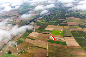 Aerial view of Paraglider over the wind farm Freckenfeld in clouds in Freckenfeld in the state Rhineland-Palatinate, Germany
