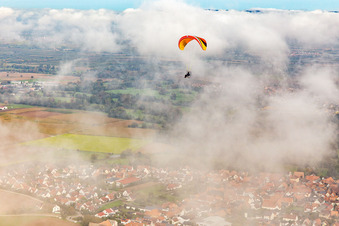 Aerial view of Village with paraglider under autumn clouds in Steinweiler in the state Rhineland-Palatinate, Germany
