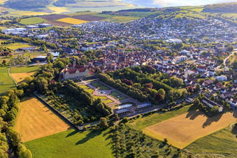 Oblique view of Castle and castle garden Weikersheim (Castle of Count Wolfgang von Hohenlohe from the 17th century with a magnificent knights' hall and garden with statues.) in Weikersheim in the state Baden-Wuerttemberg, Germany