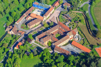 Oblique view of Hotel Kloster Bronnbach with Abbey Garden, Abbey Church of the Assumption of Mary and Missionaries of the Holy Family Monastery Bronnbach from the south in the district Bronnbach in Wertheim in the state Baden-Wuerttemberg, Germany