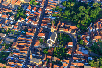 Aerial photograpy of Catholic Church of St. Nicholas and Protestant Church Bellheim on Hauptstr in Bellheim in the state Rhineland-Palatinate, Germany