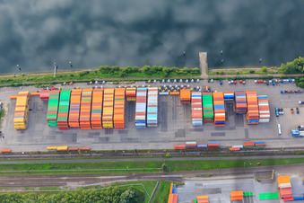 Colorful containers and trucks at the pier of Vega International Car-Transport at the Landeshafen Wörth in Wörth am Rhein in the state Rhineland-Palatinate, Germany