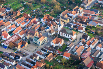 Village square with community center and VR Bank Südpfalz eG branch Ottersheim, as well as church in Ottersheim bei Landau in the state Rhineland-Palatinate, Germany