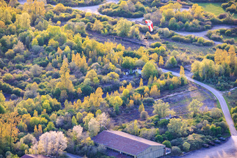 Paragliders over the hangars at the former military airfield Grostenquin in Bistroff in the state Moselle, France