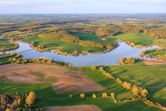 Boardwalks with fishing huts line the shore of Lake Etang du Welschhof. in Puttelange-aux-Lacs in the state Moselle, France