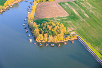 Boardwalks with fishing huts line the shore of Lake Etang du Welschhof. in Puttelange-aux-Lacs in the state Moselle, France