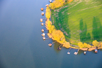 Boardwalks with fishing huts line the shore of Lake Etang du Welschhof. in Puttelange-aux-Lacs in the state Moselle, France