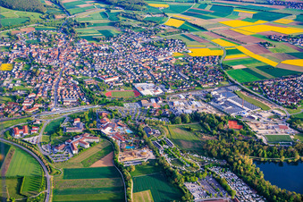 View of the spa town from the north with the Staffelstein-West industrial park and Goebel Porzellan GmbH, as well as the spa park with its lakeside stage, Obermain Therme and Schön Klinik Bad Staffelstein in Bad Staffelstein in the state Bavaria, Germany