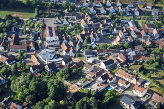 Modern church building of St. Sebastian and country inn Zur Linde in the village center in Silz in the state Rhineland-Palatinate, Germany