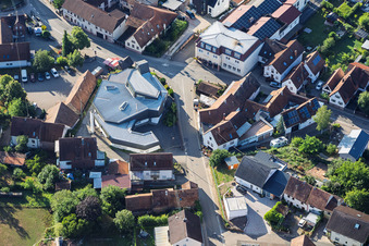 Modern church building of St. Sebastian and country inn Zur Linde in the village center in Silz in the state Rhineland-Palatinate, Germany