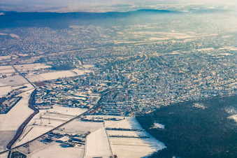 View of the town from the west under wintry high fog with snow in Sandhausen in the state Baden-Wuerttemberg, Germany