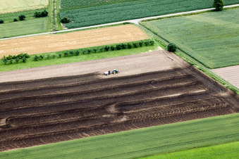 Tractor spraying manure on agricultural fields in Achern in the state Baden-Wurttemberg
