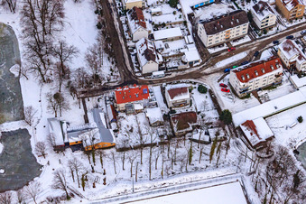 Swan pond frozen in winter in Kandel in the state Rhineland-Palatinate, Germany from above