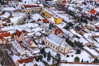 Catholic Church in winter with snow in Minfeld in the state Rhineland-Palatinate, Germany