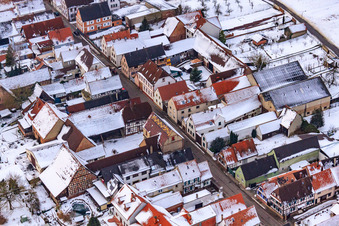 Main street in snow in Freckenfeld in the state Rhineland-Palatinate, Germany