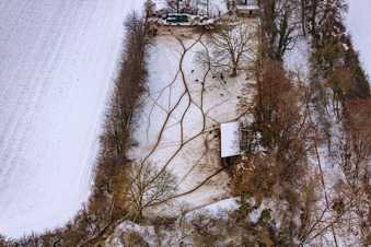 Game reserve at the Gasthaus zur Brauerei in snow in Freckenfeld in the state Rhineland-Palatinate, Germany seen from above