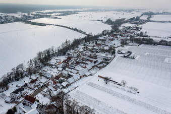 Wintry snowy Village - view on the edge of agricultural fields and farmland in Vollmersweiler in the state Rhineland-Palatinate, Germany