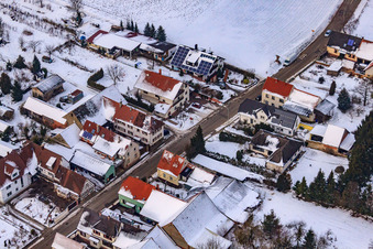 Oblique view of Main street in winter in the snow in the district Kleinsteinfeld in Niederotterbach in the state Rhineland-Palatinate, Germany