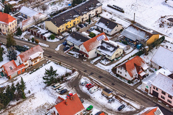 Main street in winter in the snow in Hergersweiler in the state Rhineland-Palatinate, Germany from above