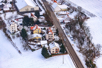 Drone recording of Main street in winter in the snow in Hergersweiler in the state Rhineland-Palatinate, Germany