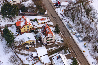 Drone image of Main street in winter in the snow in Hergersweiler in the state Rhineland-Palatinate, Germany
