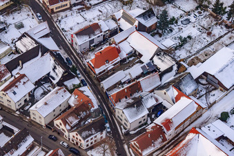 Oblique view of Raiffeisenstraße x Hauptstraße in snow in Winden in the state Rhineland-Palatinate, Germany