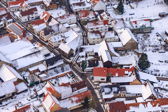 Aerial view of Raiffeisenstraße x Kuhgasse in snow in Winden in the state Rhineland-Palatinate, Germany