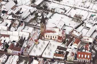 Wintry snowy Catholic Church building in the village of in Steinweiler in the state Rhineland-Palatinate, Germany
