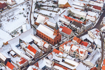 Protest. Church in the snow in Steinweiler in the state Rhineland-Palatinate, Germany seen from above