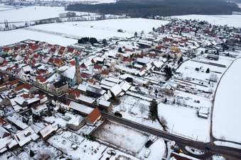 Aerial view of Kandeler Straße x Hauptstraße in winter with snow in Erlenbach bei Kandel in the state Rhineland-Palatinate, Germany