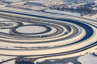 Oblique view of Oberwald industrial area, Daimler truck test track in winter with snow in Wörth am Rhein in the state Rhineland-Palatinate, Germany
