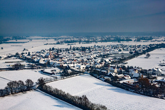 Wintry snowy Village - view on the edge of agricultural fields and farmland in Neupotz in the state Rhineland-Palatinate